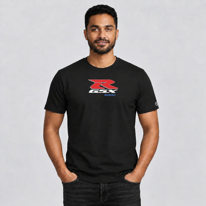 Male model wearing a black Stylingo Suzuki GSX R motorcycle graphic T-shirt in a casual lifestyle setting.